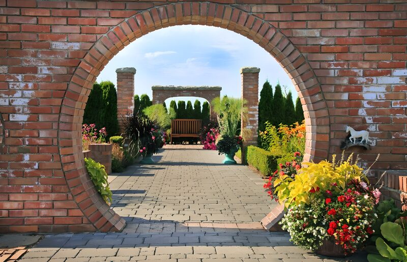 Charming Brick Archway in Blooming Garden