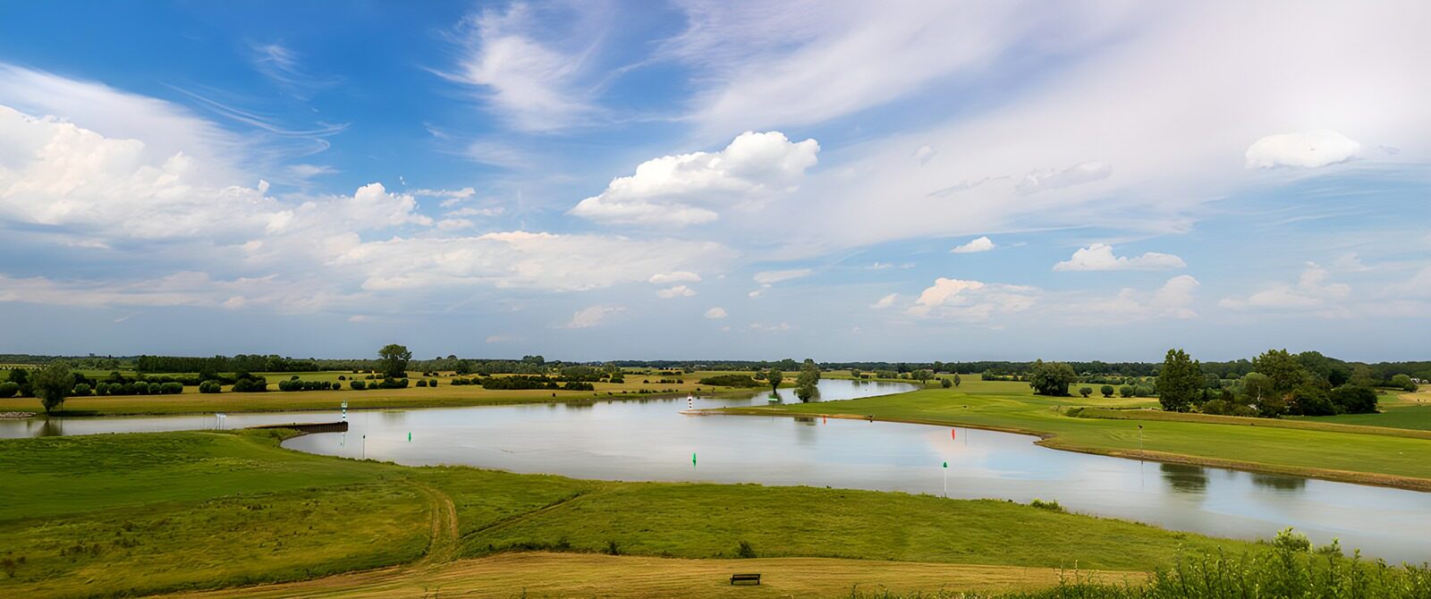 Serene River Landscape Under Blue Skies