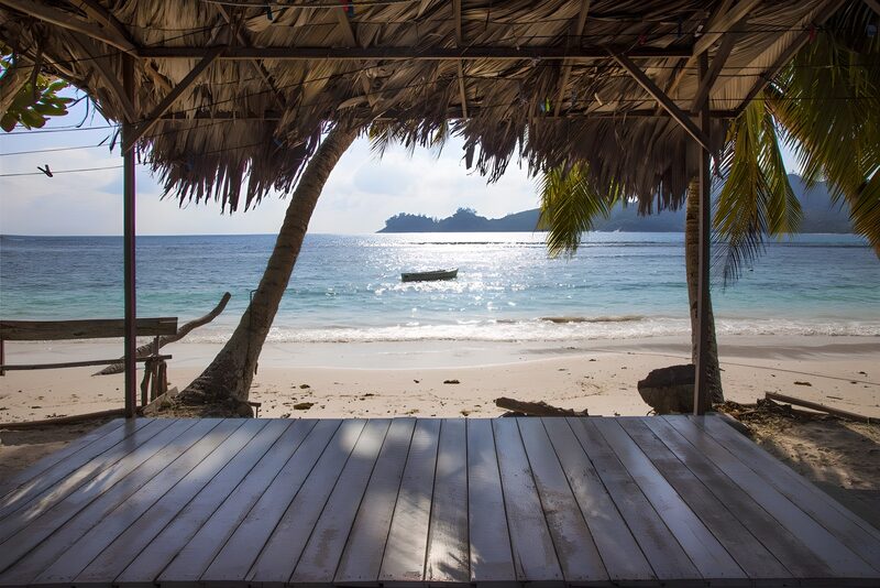 Serene Beach Escape with Palm Roof