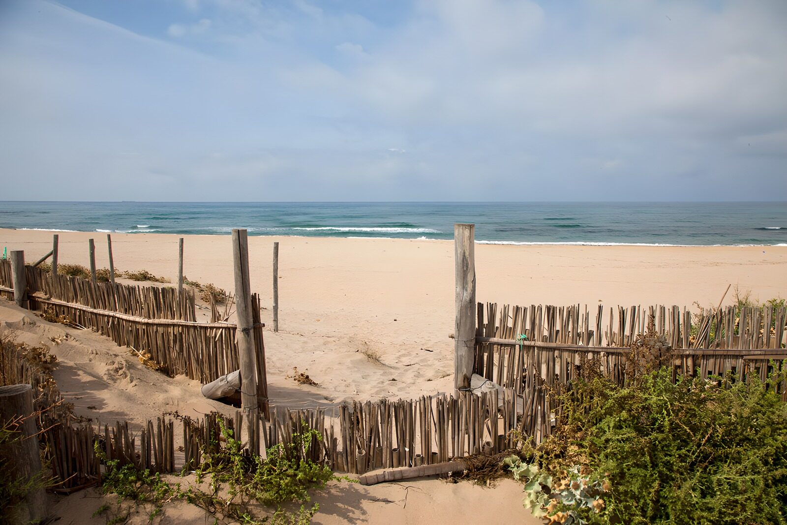 Tranquil Beach View with Wooden Fence