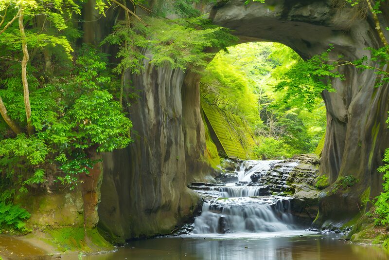 Serene Waterfall Through Natural Archway