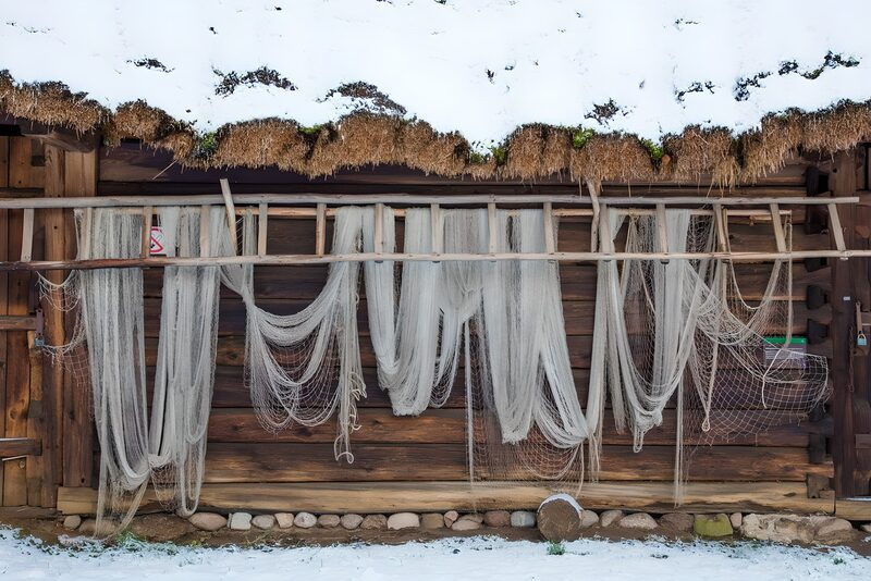 Hanging Fishing Nets Against a Wooden Wall